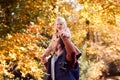 Father Playing Game Carrying Daughter On Shoulders On Family Walk Along Track In Autumn Countryside