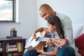 Father playing guitar with daughter Royalty Free Stock Photo