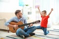 Father playing guitar for his son Royalty Free Stock Photo