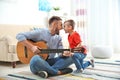 Father playing guitar for his son Royalty Free Stock Photo