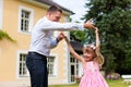 Father is playing with his daughter on a meadow Royalty Free Stock Photo