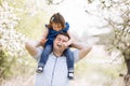 Father playing with his daughter in the park. Daughter sitting on father shoulders. Portrait of happy family. father`s, baby`s d Royalty Free Stock Photo