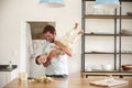 Father Playing With Son As They Prepare Food In Kitchen Royalty Free Stock Photo