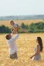 Father playing with son on the wheat field Royalty Free Stock Photo