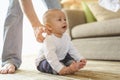 Father playing with toddler baby son having fun at home in holiday.