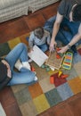 Father playing with toddler while the mother is looking at them Royalty Free Stock Photo