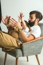 Father playing with young son in their sitting room Royalty Free Stock Photo