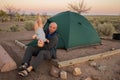 A father plays with his baby son at the tent in campground of Ho