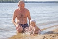 Father plays with his daughter in the lake in summer, happy family on summer vacation Royalty Free Stock Photo