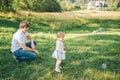 Father plays with his daughter with soapbubble