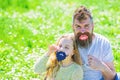 Father posing with lips and child posing with beard photo booth attribute. Gender roles concept. Dad and daughter sits Royalty Free Stock Photo