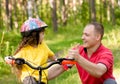 Father praises his daughter, who learned to ride a bike Royalty Free Stock Photo