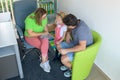 Father and preschooler daughter in therapist office during counselling assessment meeting. Social worker talking to single father. Royalty Free Stock Photo