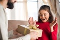 father presenting gift box to excited