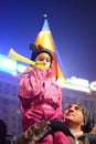 Father protesting with child against the government in Bucharest