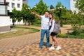 Father proudly hugs his schoolgirl daughter before she goes to school.