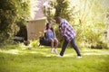 Father Pushing Daughter On Tire Swing In Garden Royalty Free Stock Photo