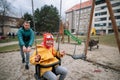 Father pushing his little daughter with Down syndrome on swing outdoors in playgraound. Royalty Free Stock Photo