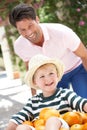 Father Pushing Son In Wheelbarrow