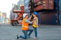 Father puts a safety helmet on little daughter at Container cargo site. Business heir concept. Happy father wearing safety helmet