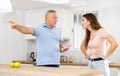 Father quarrel with adult daughter members in kitchen