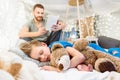 Father reading book to cute little boy sleeping with teddy bear Royalty Free Stock Photo