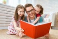 Father reading a book to his daughters Royalty Free Stock Photo