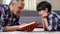 Father reading preschool child interesting story book, spending time together