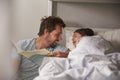 Father Reading Story To Daughter At Bedtime Royalty Free Stock Photo