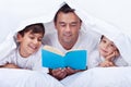 Father reading to his sons Royalty Free Stock Photo