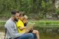 Father reading to his sons on vacation in park Royalty Free Stock Photo