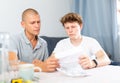 Father reassures his son after reading letter from college