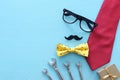 Father`s day concept. gift box, tie and funny moustache over wooden background. top view, flat lay