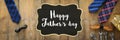 Father`s day concept. gift box, tie and funny moustache over wooden background. top view, flat lay. banner