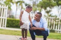 Father's day concept, Father helping her little daughter to ride a skateboard