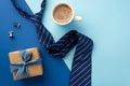 Father`s Day concept. Top view photo of craft paper gift box with silk ribbon bow blue tie cup of frothy coffee and cufflinks on Royalty Free Stock Photo