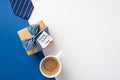 Father`s Day concept. Top view photo of craft paper giftbox with striped ribbon bow and postcard blue necktie and cup of coffee o Royalty Free Stock Photo
