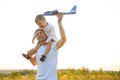 Father& x27;s day. dad and baby son playing together outdoors plane Royalty Free Stock Photo