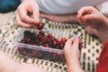 Father`s day. Dad and son eating cherries together on the beach. Happy family father and child. Royalty Free Stock Photo