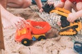 Father`s day. Dad and son. Little son plays toys with dad on the beach with sand.