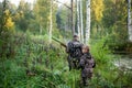 Father`s day. Father with gun showing something to son while hunting on a nature. Happy family, Fathers Day and local Royalty Free Stock Photo