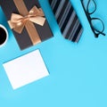 Father`s Day gift. Top view design concept of holiday greeting idea with card on blue background Royalty Free Stock Photo