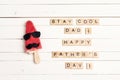 Father`s Day greeting card with funny ice cream and wooden tiles