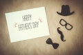 Fathers day greeting card. White card with decorative elements on craft paper background