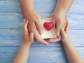 Father`s Day Hands Dad and Child Gift Box Heart on a Blue Wooden Background