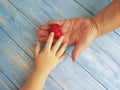 Father`s Day Hands Dad and Child giving creative holding thankful Heart on a Blue Wooden Background Royalty Free Stock Photo