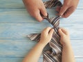 father`s day hands dad and child tie against blue wooden background Royalty Free Stock Photo