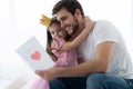 Father`s day. Happy family daughter giving dad a greeting card on holiday. Royalty Free Stock Photo