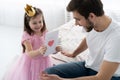 Father`s day. Happy family daughter giving dad a greeting card on holiday. Royalty Free Stock Photo