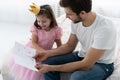 Father`s day. Happy family daughter giving dad a greeting card on holiday. Royalty Free Stock Photo